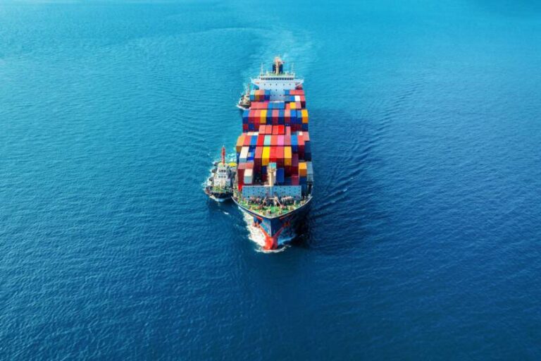 aerial-view-cargo-ship-with-cargo-container-sea_335224-1372-840x560