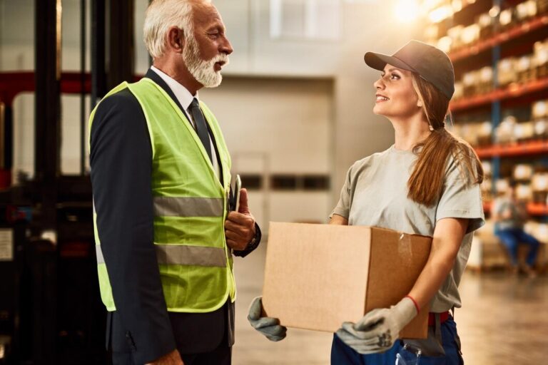 mature-manager-communicating-with-female-distribution-warehouse-worker-industrial-building_637285-4899